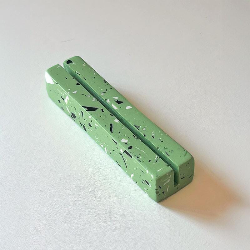 Green textured rectangular object on a white background