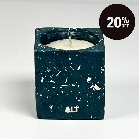 A rectangular navy candle holder with white terrazzo, containing a white tea light candle. The word 'ALT' is printed in white near the bottom front. With 20% off badge