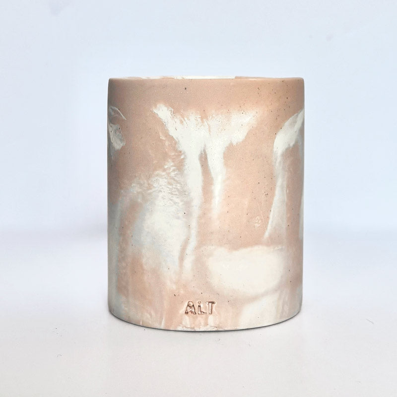 Marble-patterned salmon pink pen pot with 'ALT' branding on a white background