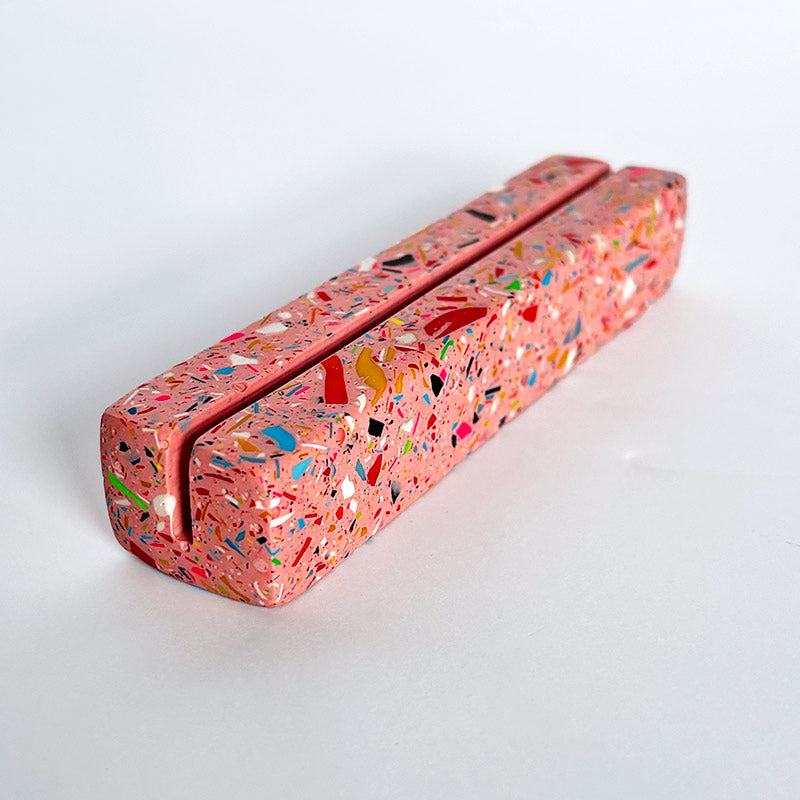 Rectangular pink rainbow terrazzo photo holder on a white background