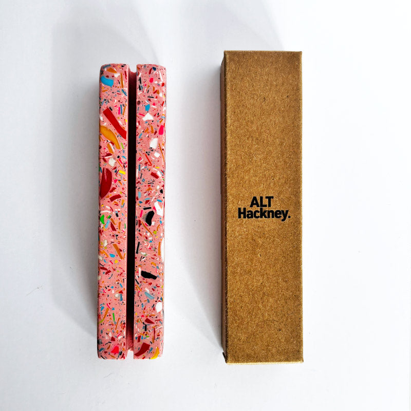 Rectangular pink rainbow terrazzo photo holder next to a brown box with 'ALT Hackney.' branding on a white background