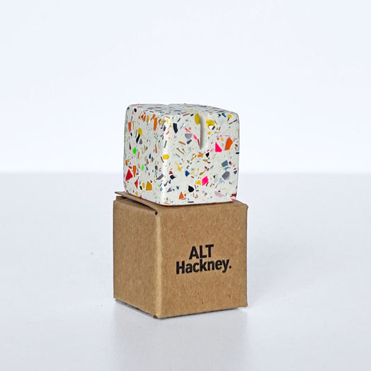 Rainbow terrazzo photo holder on a brown eco box with 'ALT Hackney' branding on a white background