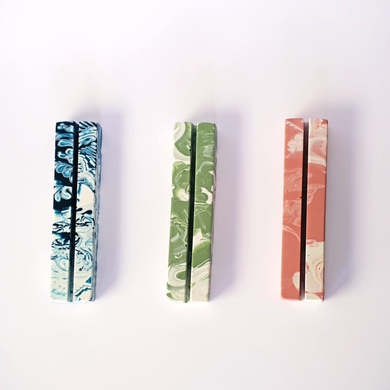 Three marbled patterned rectangular photo holders on a white background