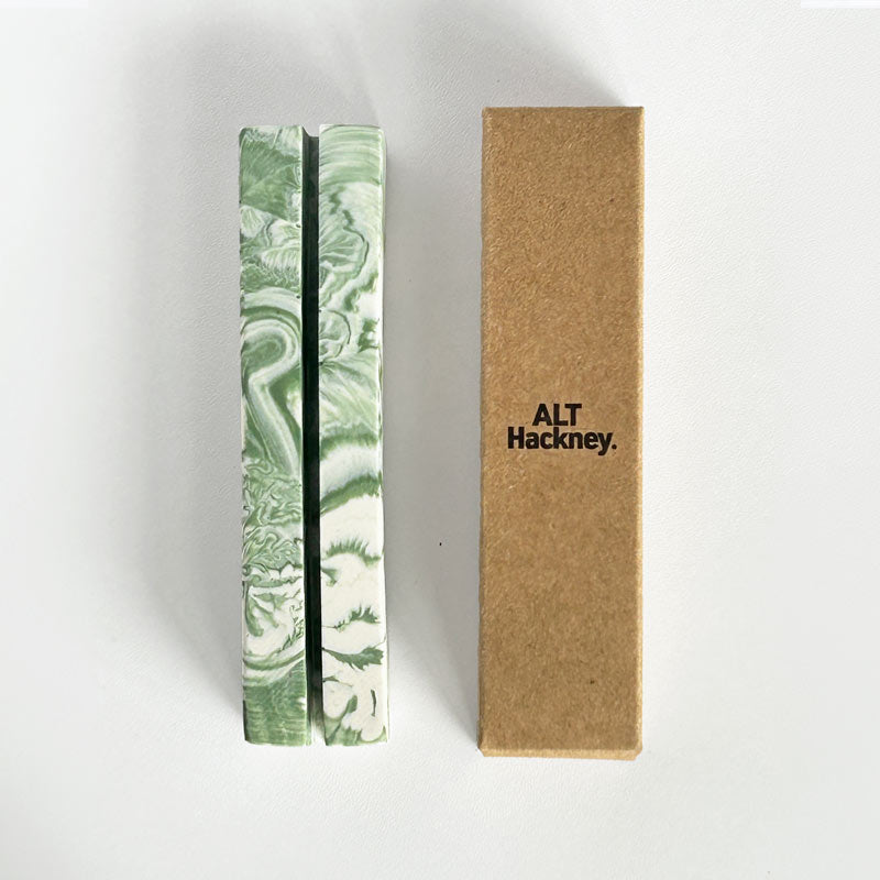 Moss Green marble patterned rectangular photo holder next to a brown box with 'ALT Hackney.' branding on a white background