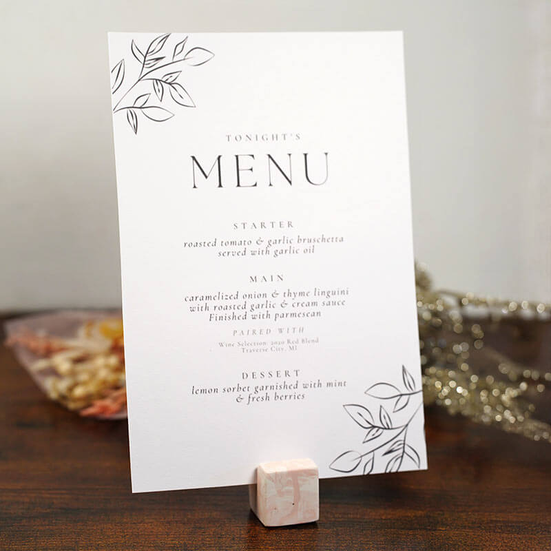 Wedding table name card with photo and name on a wooden surface