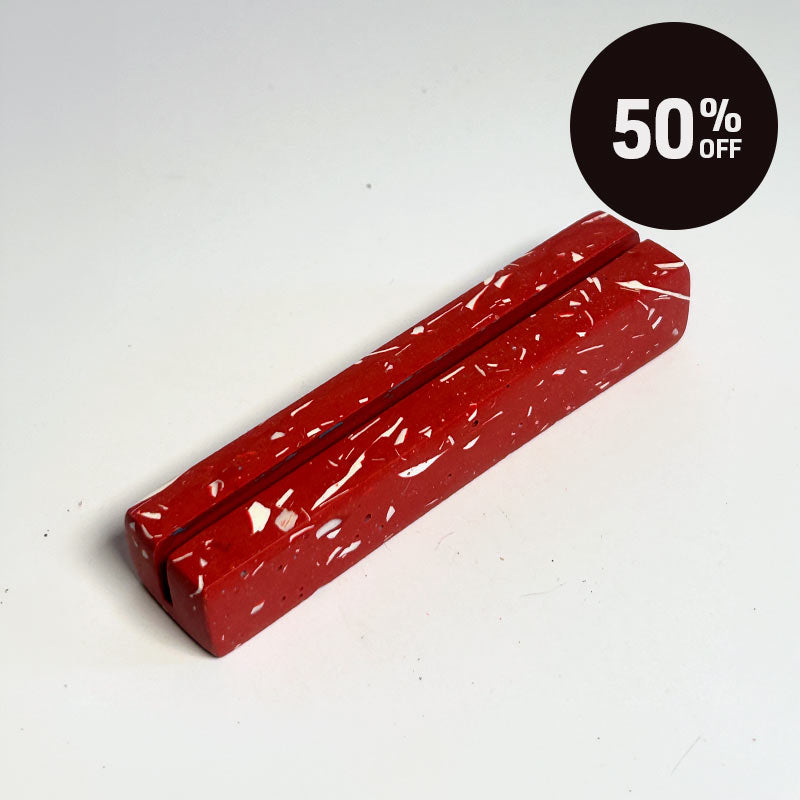 A terracotta red photo holder with a white speckled pattern, shown on a white background with a black '50% OFF' promotional badge in the top right corner.