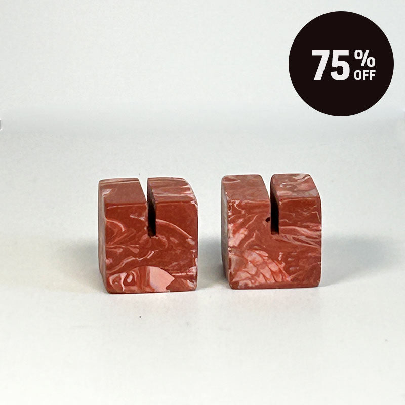Two small terracotta red cube-shaped photo holders on a plain light background. A black circular badge in the top right reads '75% OFF'.