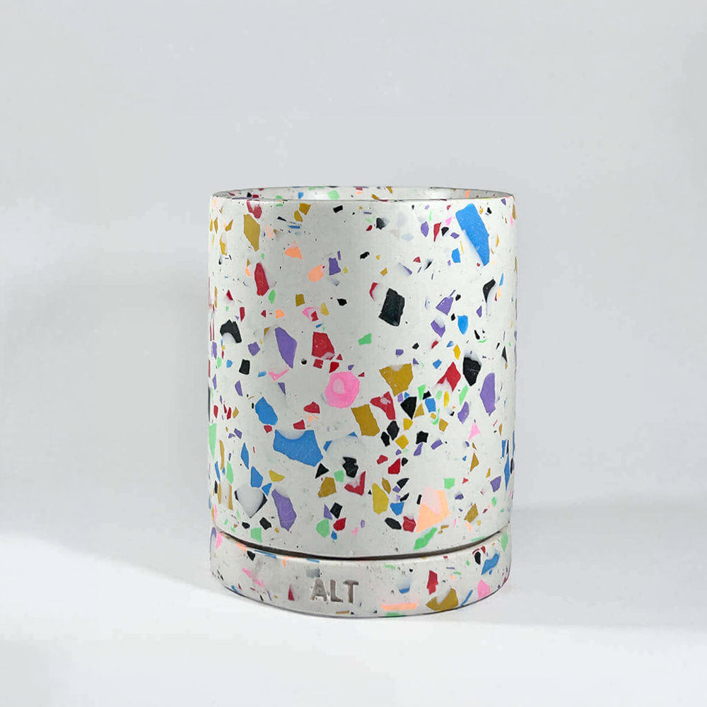 Colourful terrazzo-patterned plant pot with drainage and a separate water tray on a white background