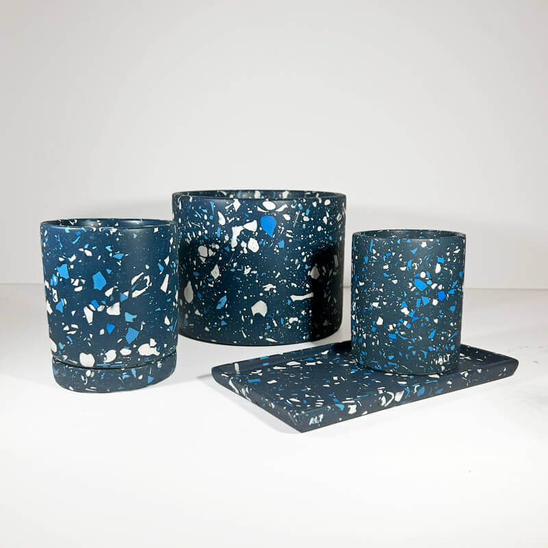 Set of three blue and white speckled planters on a white background