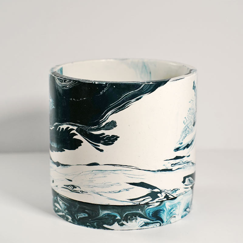 Navy marble-patterned plant pot a white background