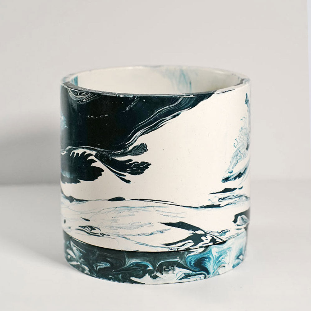 Navy marble-patterned plant pot a white background