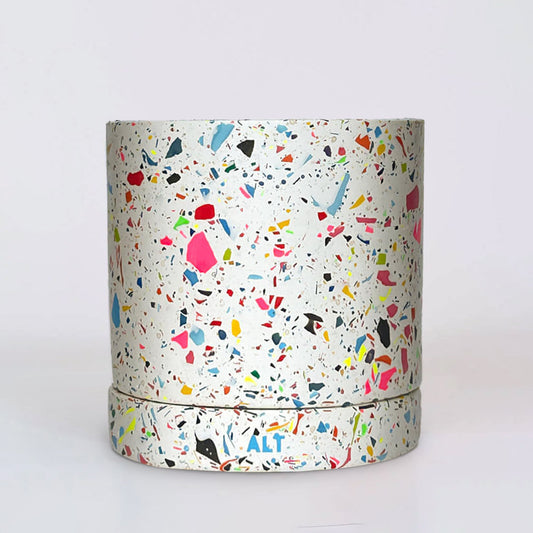 Colourful rainbow terrazzo pot on a white background