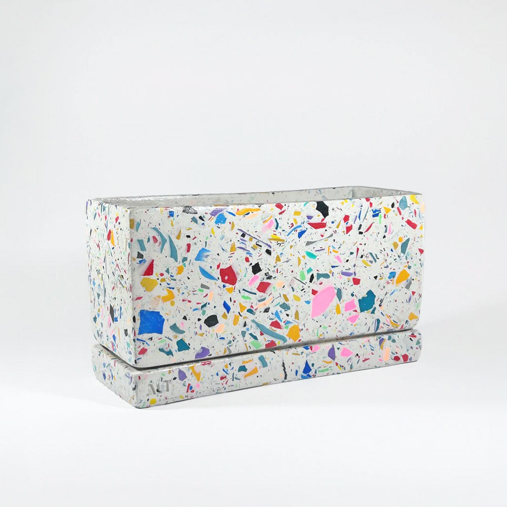 Rectangular rainbow colourful confetti terrazzo planter with drainage holes and a water tray box on which background