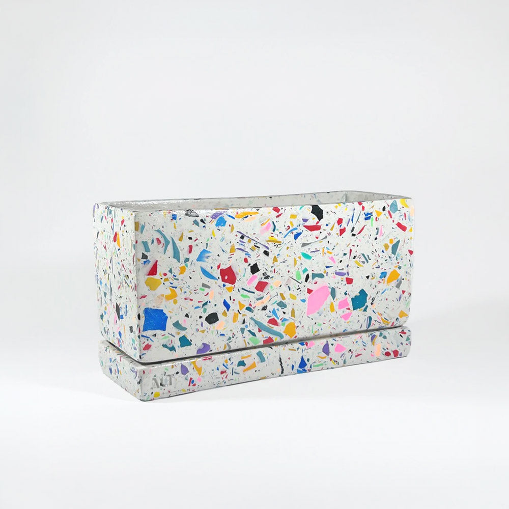 Rectangular rainbow colourful confetti terrazzo planter with drainage holes and a water tray box on which background