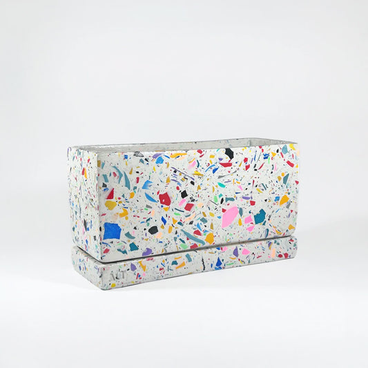 Rectangular rainbow colourful confetti terrazzo planter with drainage holes and a water tray box on which background