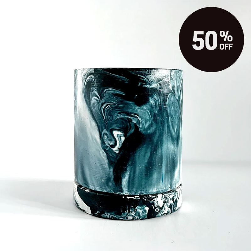 A cNavy marbled navy and white plant pot with a drainage hole and a water tray  on a white background with a black circular '50% OFF' promotional badge in the top right corner.