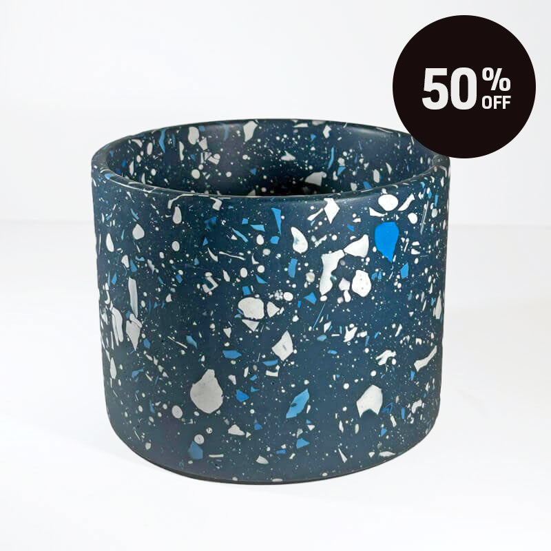 A large navy with white terrazzo planter pot. A black circular badge in the top right corner reads '50% OFF'.