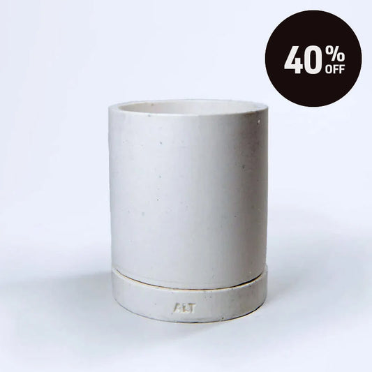 A minimalist, cylindrical planter in a matte off-white glaze with a matching base, featuring the embossed letters 'ALT' on the front. A black circular promotional sticker with '40% OFF' is in the top right corner against a clean white background.