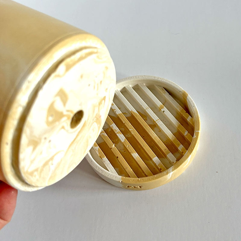 Marbled beige and white plant pot with drainage hole and a water tray with 'ALT' branding on a white background
