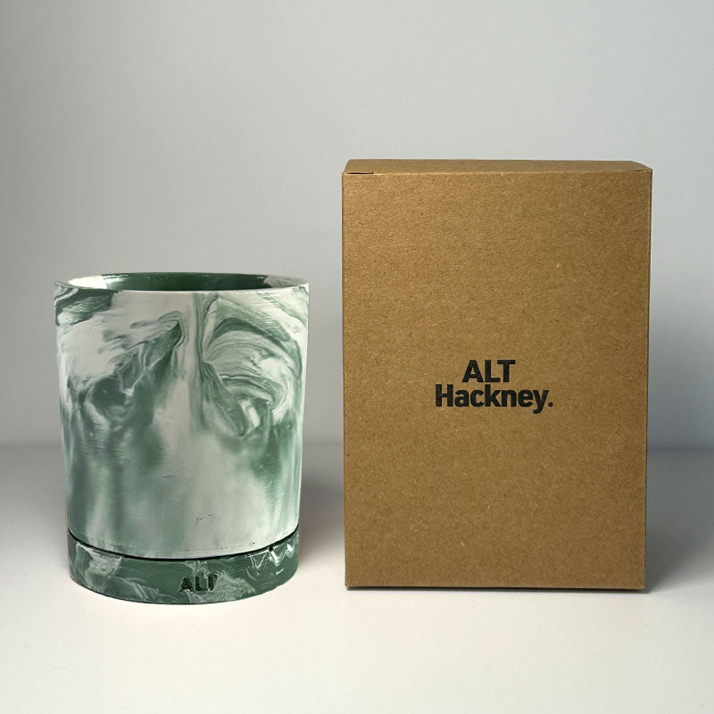 Marble-patterned moss green plant pot with a brown box labeled 'ALT Hackney' on a gray background