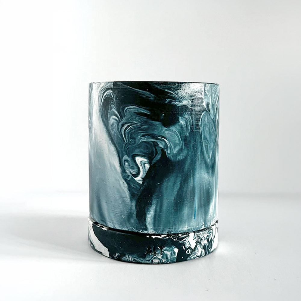 Navy marbled navy and white plant pot with a drainage hole and a water tray  on a white background