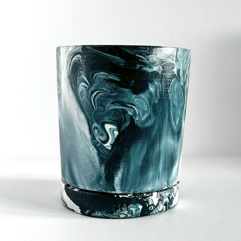 Navy marbled navy and white plant pot with a drainage hole and a water tray  on a white background
