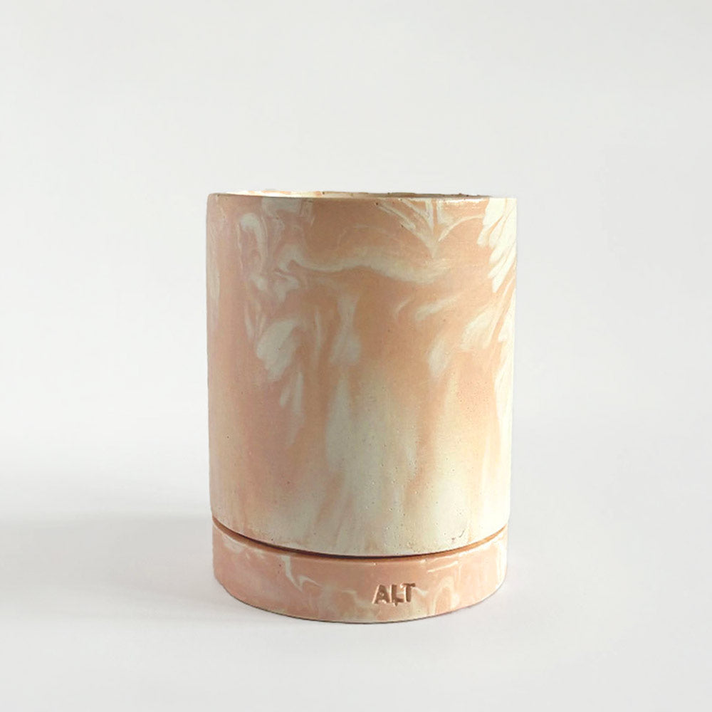 Marbled salmon pink planter with a drainage hole and a water tray with 'ALT' branding on a light gray background