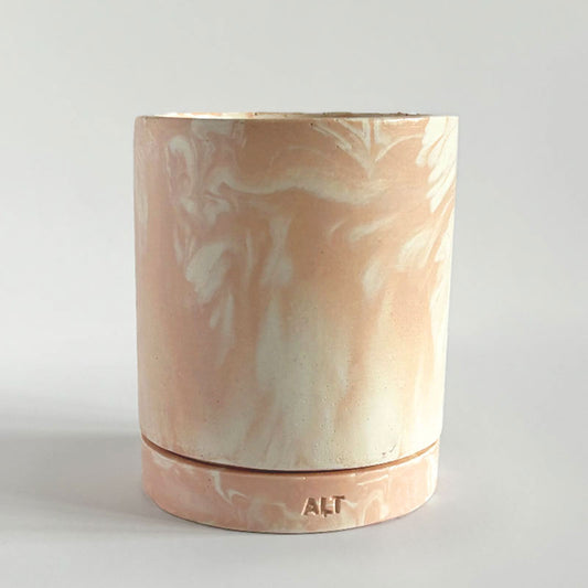 Marbled salmon pink planter with a drainage hole and a water tray with 'ALT' branding on a light gray background