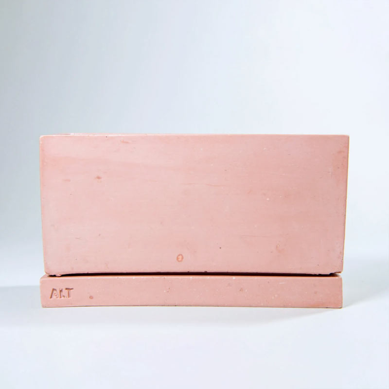 A rectangular dusty rose coloured planter pot with a matching saucer base, shown on a light grey background