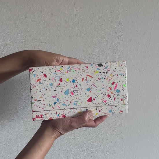 Hands holding a Large Rectangular Rainbow Terrazzo Jesmonite Plant Pot with Drainage holes & Saucer on a white background 