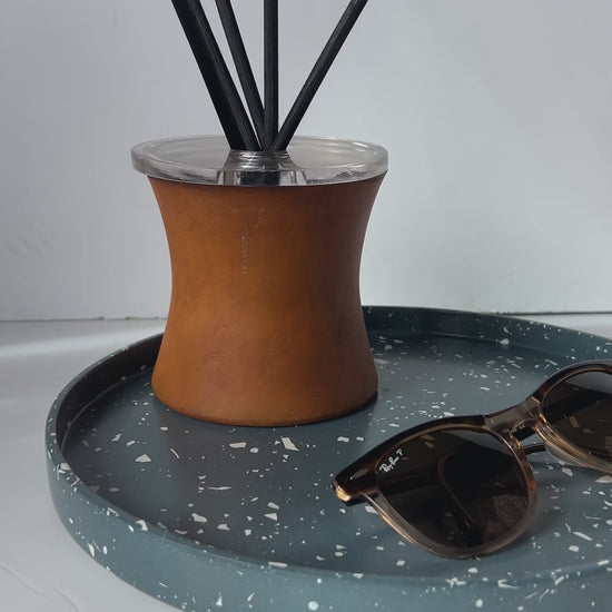 Large Round Navy terrazzo Tray with Diffuser and a pair of Rayban glasses
