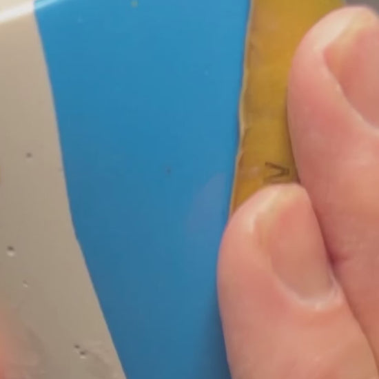 A hand holding a chunky terrazzo pen pot