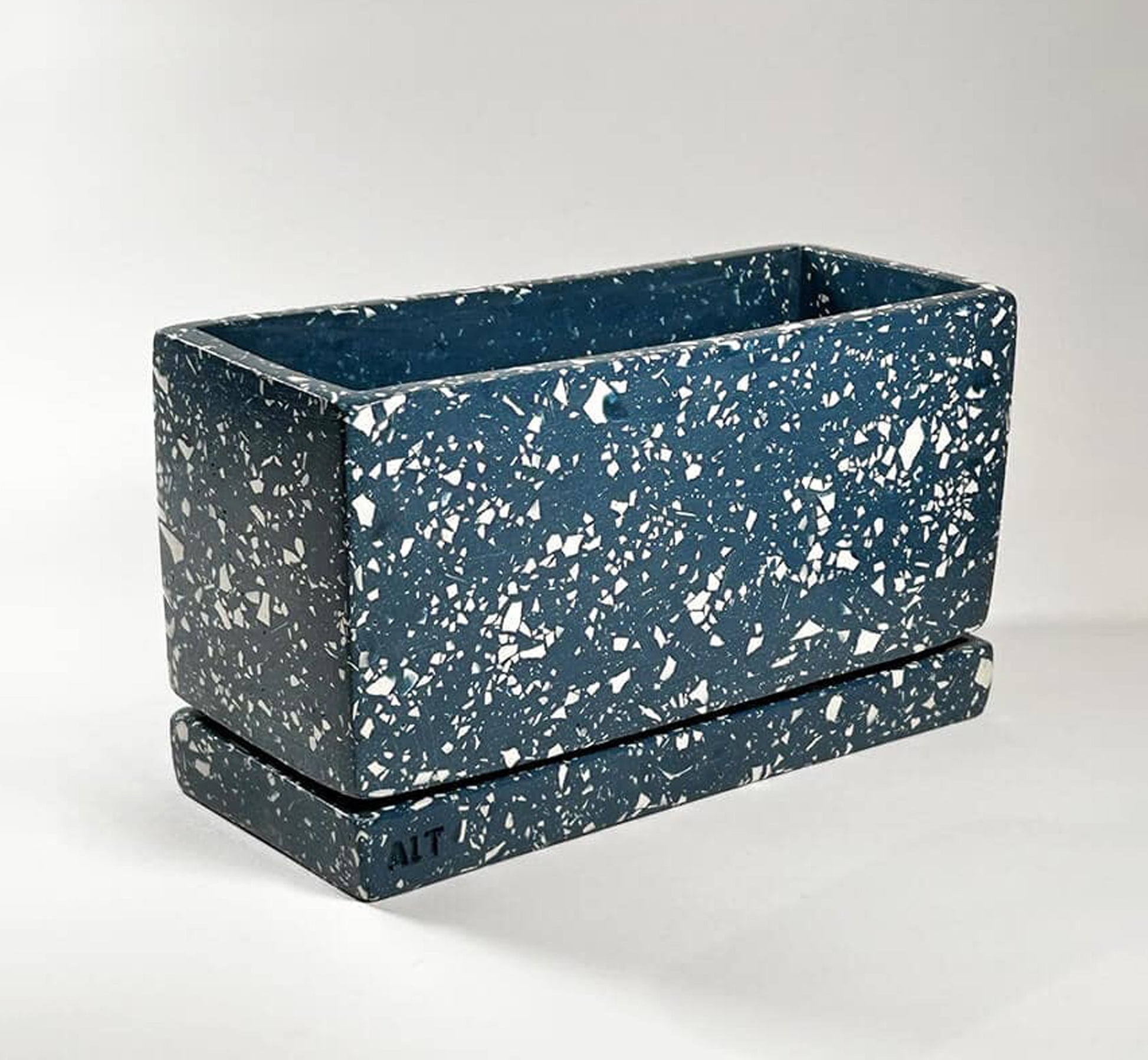 Behind-the-scenes video showing the handmade process of creating a rectangular navy terrazzo Jesmonite plant pot, including casting, finishing, and crafting details in a Hackney studio
