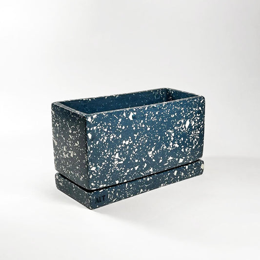 Navy rectangular terrazzo planter with drainage holes and a water tray on a white background
