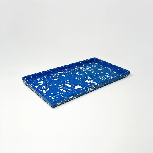 Blue tray with white terrazzo on a light grey background