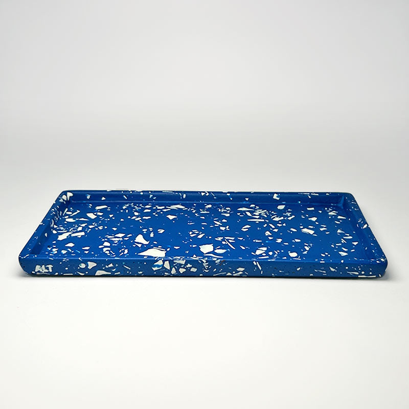 Blue tray with white terrazzo on a light grey background