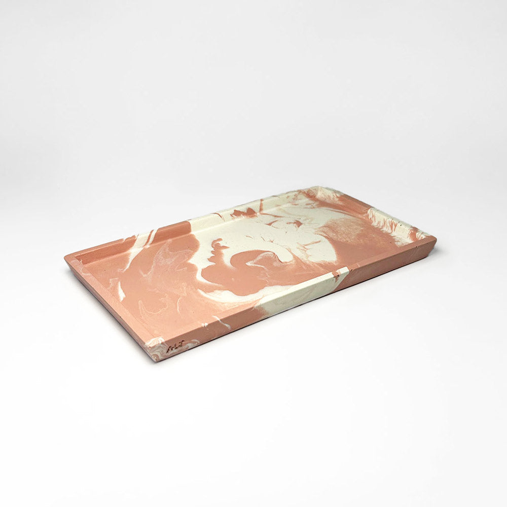 Marbled pink and white rectangular tray on a light gray background