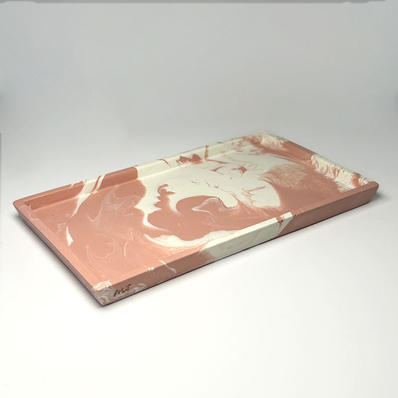 Marbled pink and white rectangular tray on a light gray background