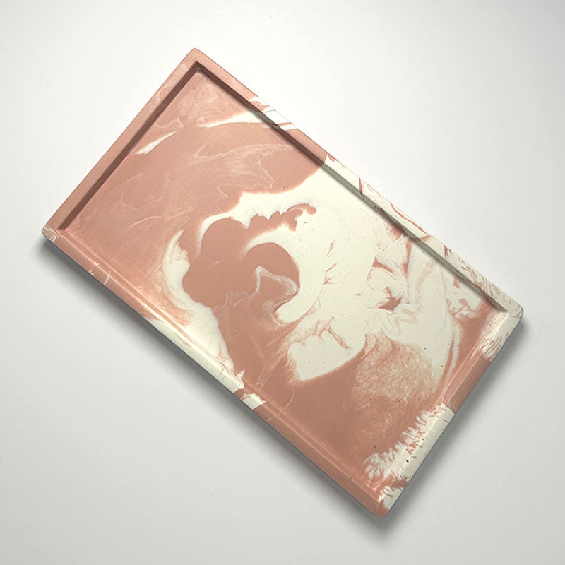 Marble-patterned pink and white tray on a light gray background