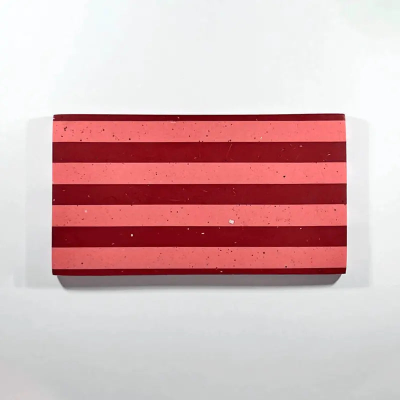 A rectangular tray with horizontal stripes in dark red and coral pink, shown against a plain white background.