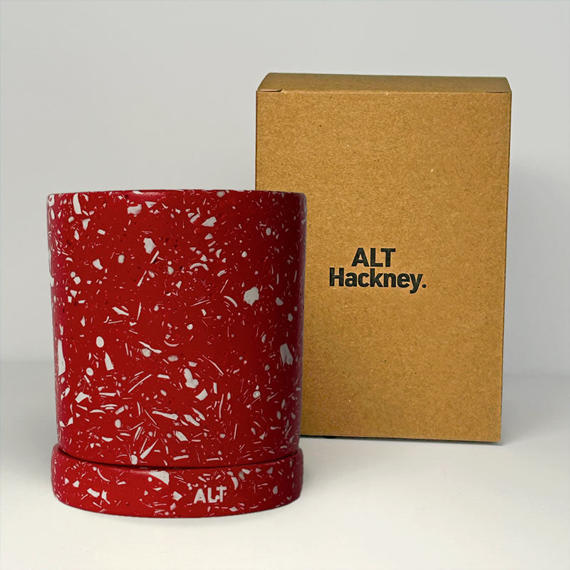 Red with white terrazzo planter with a brown box labeled 'ALT Hackney' on a white background