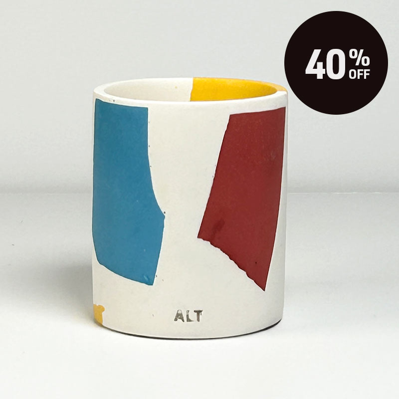 A pen pot with blue, red, and yellow colour block design featuring the text 'ALT' near the bottom. A black circular sticker overlay in the top right corner reads '40% OFF'.