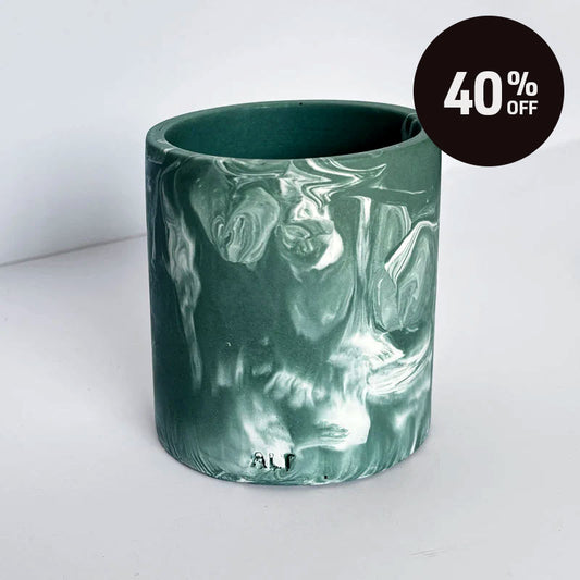 A cylindrical pen pot with a marbled green and white pattern, shown on a light gray background with a black '40% OFF' promotional sticker in the top right corner.