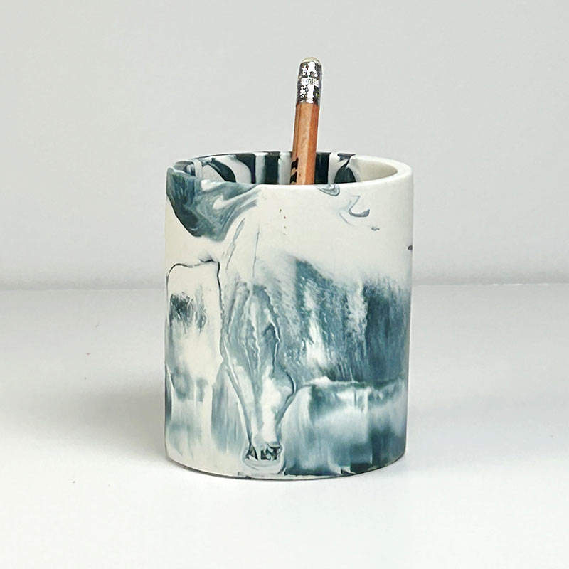 Marble-patterned pen pot with 'ALT' branding with a pencil on a white background