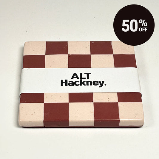 Dark red and light sand checkerboard patterned coaster on a white background, wrapped in a white paper band labeled 'ALT Hackney.', on a light off-white background with a black '50% OFF' promotional sticker in the top right corner.