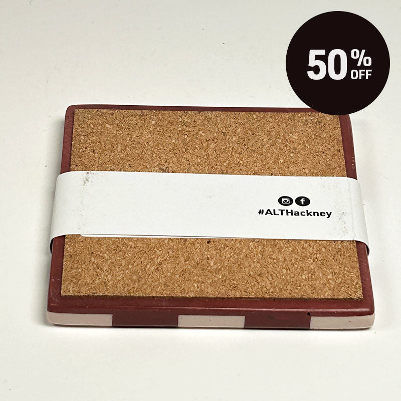 A square cork board with a Dark red and light sand checkerboard patterned coaster on a white background, and a white paper band wrapped around it, featuring the text '#ALTHackney' and a small social media icons. A black circular sticker overlay in the top right corner reads '50% OFF'.