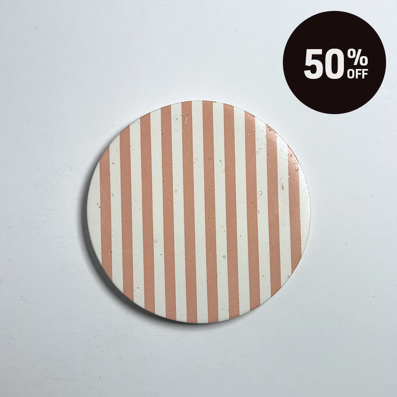 A round coaster with vertical peach and white stripes, shown on a light gray background with a black circular '50% OFF' promotional sticker in the top right corner.