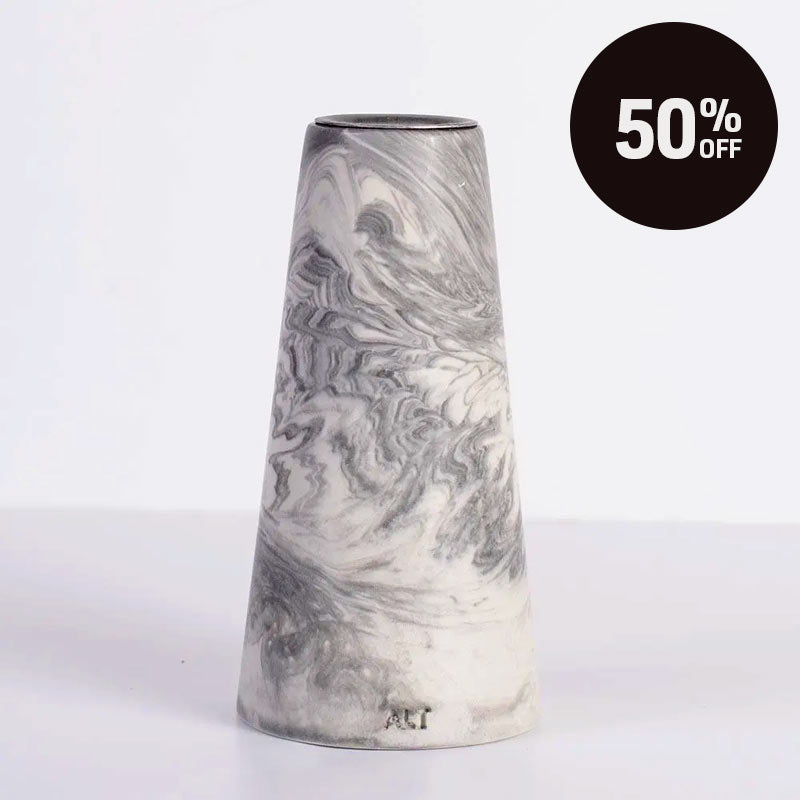 A grey marble patterned tapered candle, shown on a white background with a black circular '50% OFF' sale badge in the top right corner.