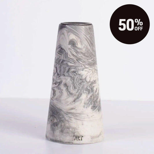 A grey marble patterned tapered candle, shown on a white background with a black circular '50% OFF' sale badge in the top right corner.