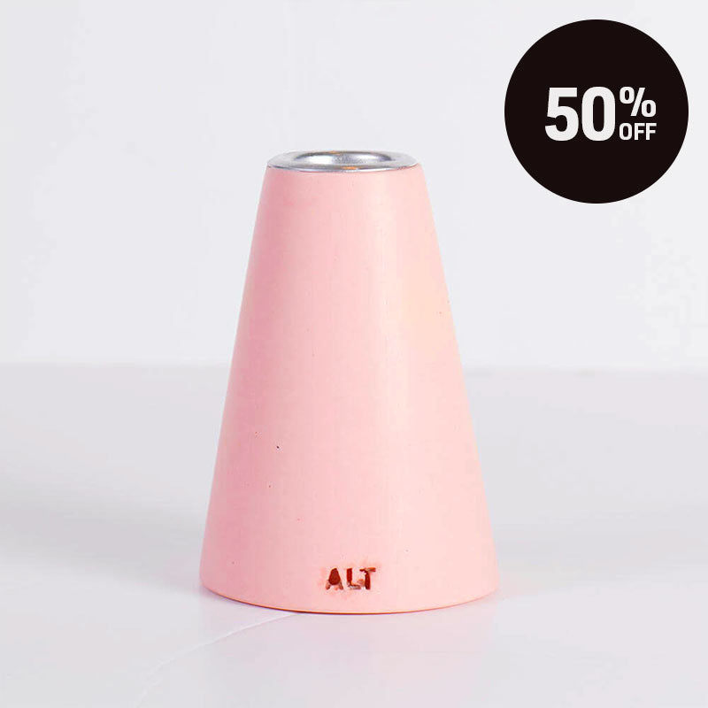 A pink taper candle holder with a silver-toned top, shown on a white background with a black '50% OFF' promotional badge in the top right corner.